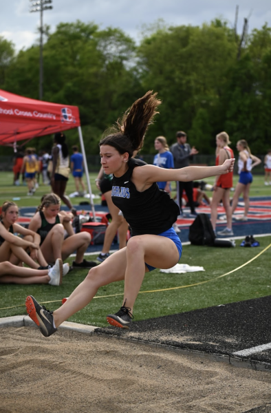 Junior Kate Fausz completes in the long jump and trying to get the technique down.